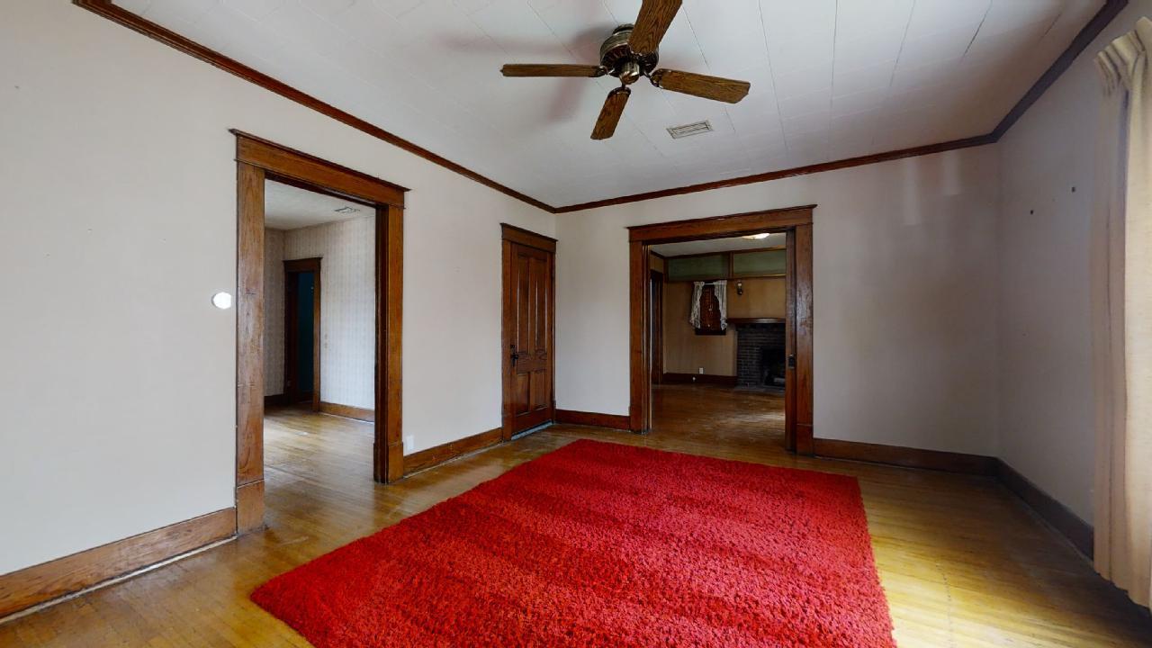 208 East State Street Fairmount, IL 61841 - Photo 3 of 42 a view of a hallway with wooden floor and a ceiling fan