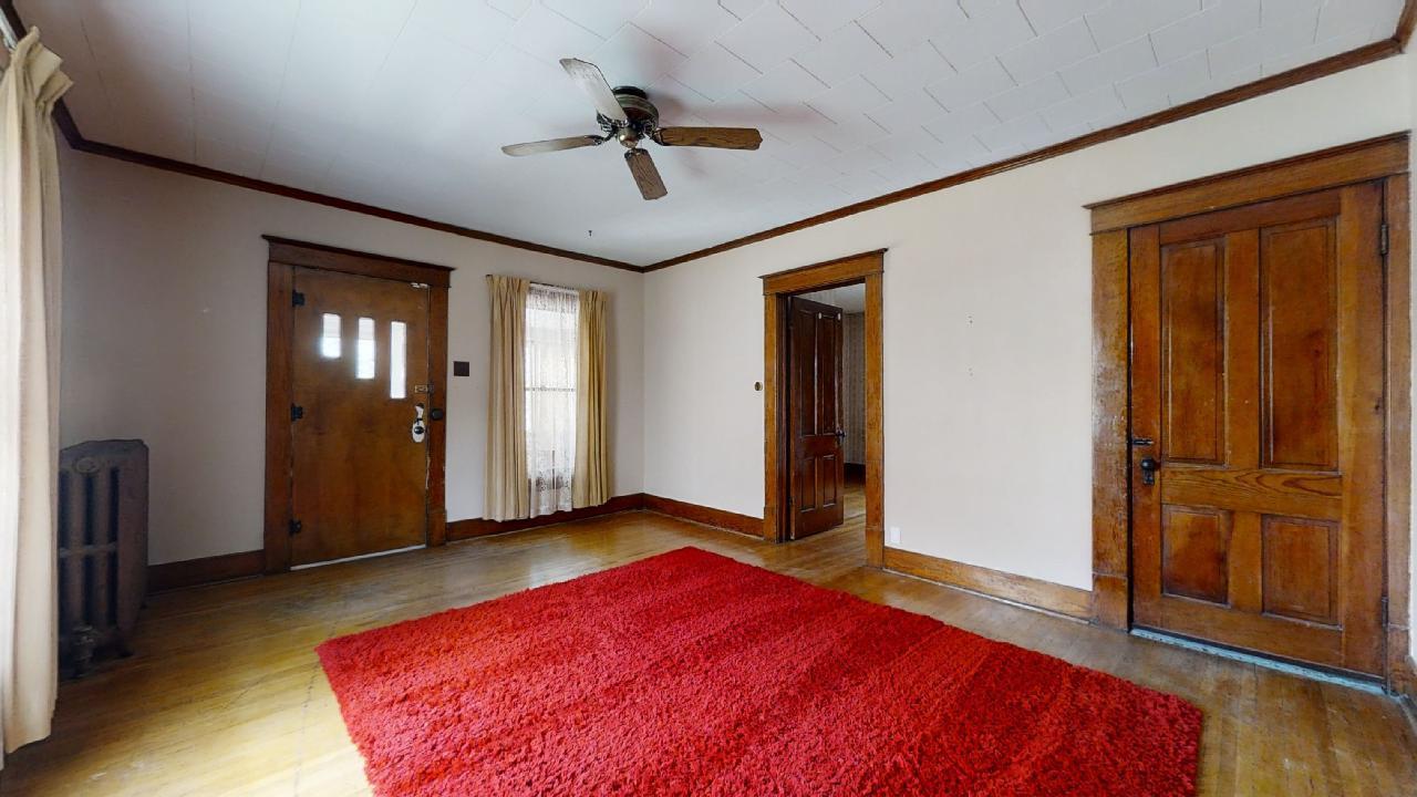 208 East State Street Fairmount, IL 61841 - Photo 4 of 42 a bedroom with a bed and a chandelier