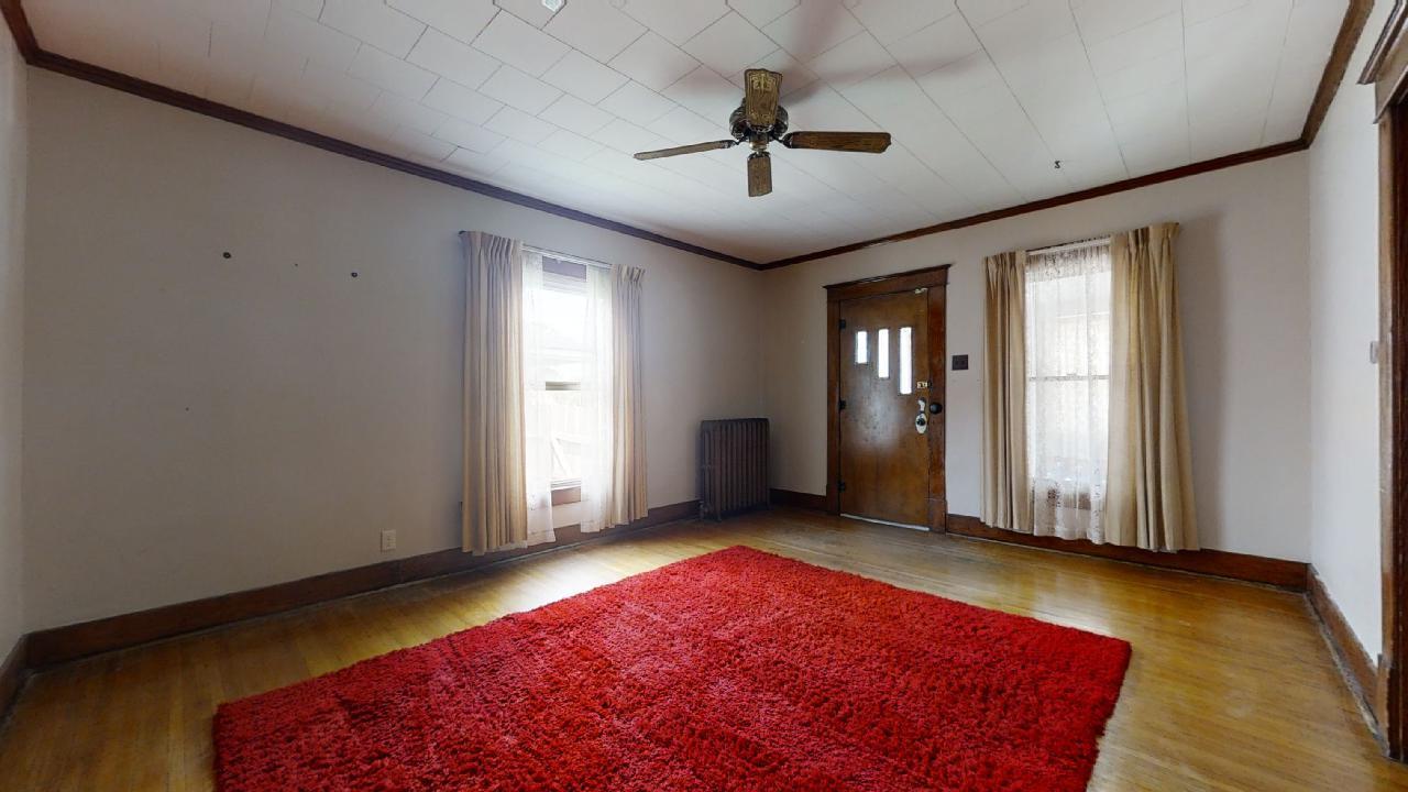 208 East State Street Fairmount, IL 61841 - Photo 5 of 42 a view of a livingroom with a chandelier fan and windows