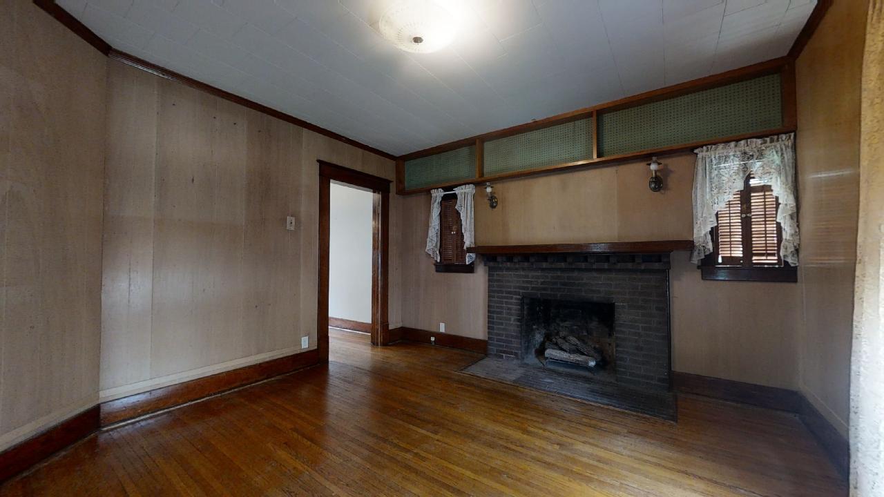 208 East State Street Fairmount, IL 61841 - Photo 7 of 42 a view of an empty room with wooden floor fireplace and a window