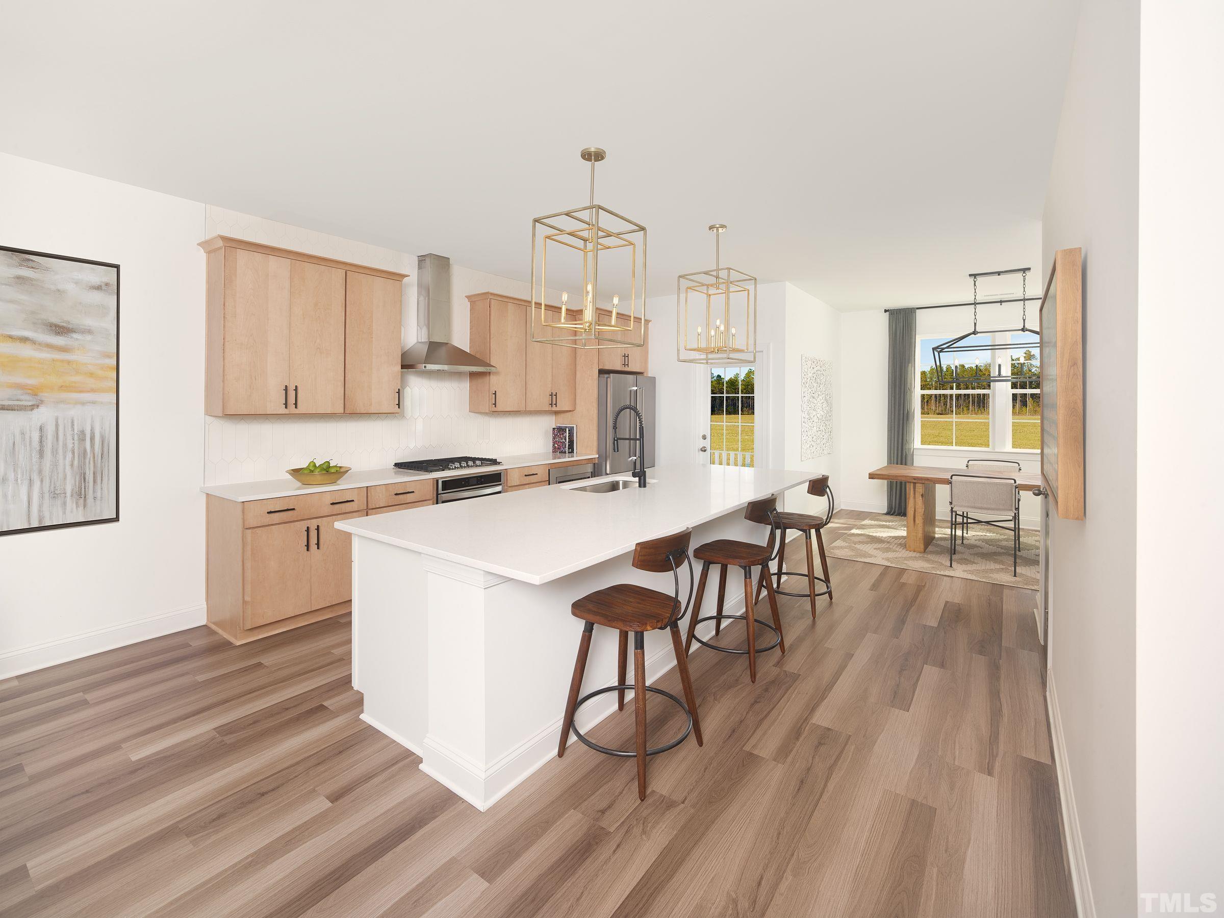 515 Bistre Drive, Unit 245 Cary, NC 27519 - Photo 2 of 16 a kitchen with a table chairs stove and cabinets