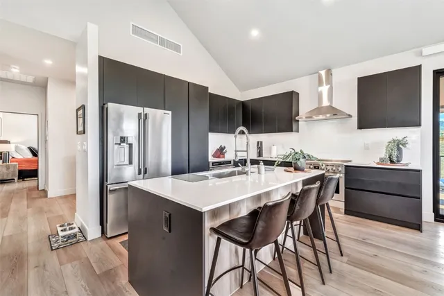 a large kitchen with a table and chairs