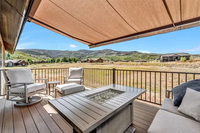 a view of a balcony with wooden floor and outdoor seating