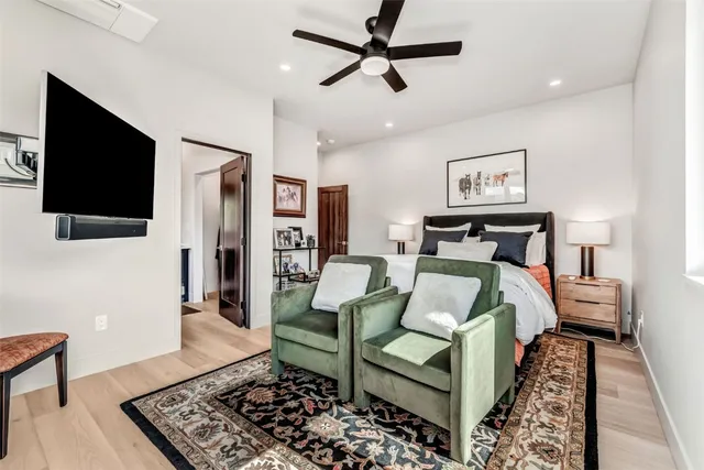 a bedroom with a bed and a flat screen tv