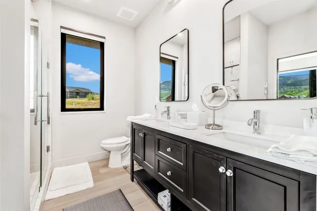 a bathroom with a double vanity sink and a mirror