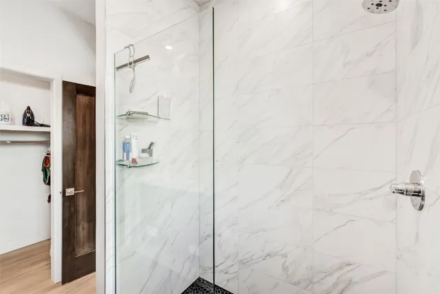 a bathroom with a shower and a glass door