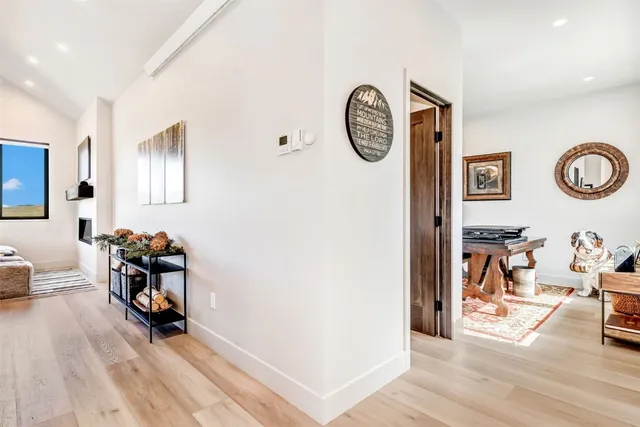 a living room with couch and a large mirror next to a window