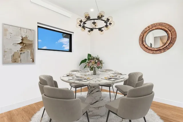a dining room with furniture and a chandelier