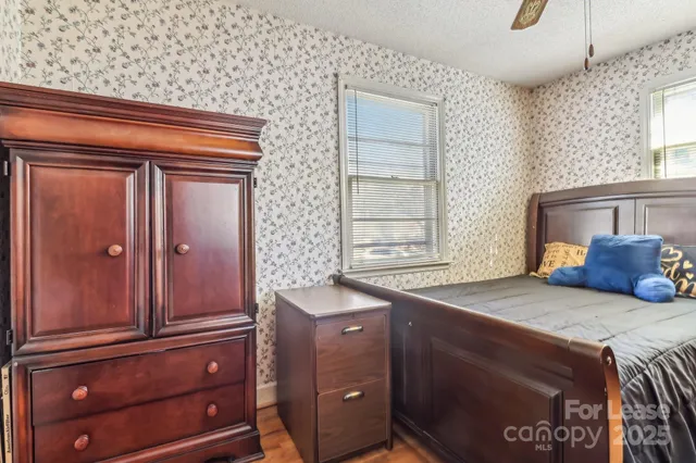 a kitchen with a wooden floor and cabinets