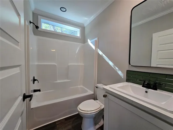 a bathroom with a sink a toilet and a bathtub
