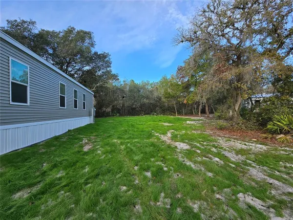 a backyard of a house with lots of green space