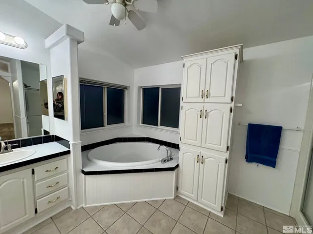 a view of a house with a yard and a large tree