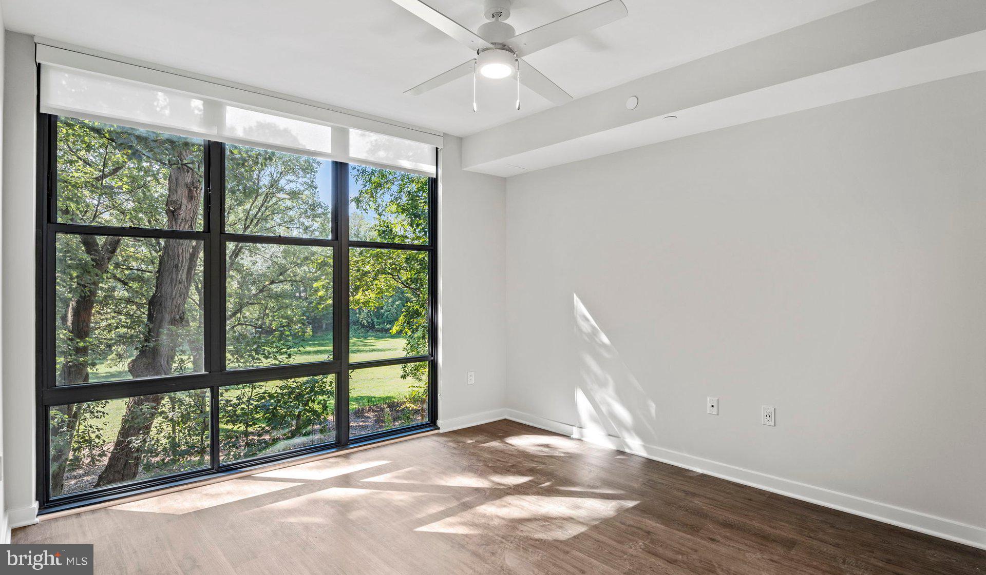 3990 Upton Street Northwest, Unit 1BPARC3101 Washington, DC 20016 - Photo 33 of 49 a view of empty room with wooden floor and fan