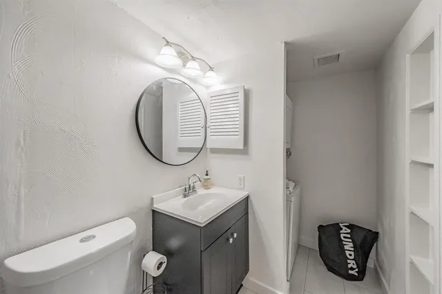 a bathroom with a toilet a sink and mirror