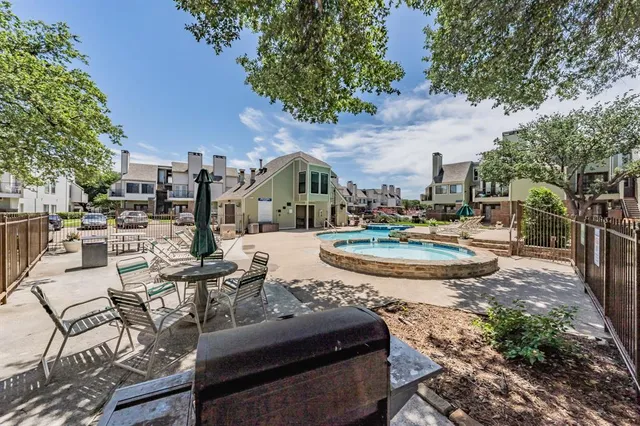 a view of a swimming pool with outdoor seating