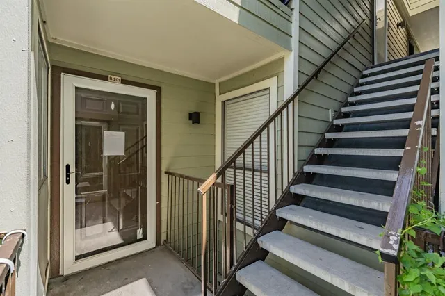 a view of entryway with wooden floor and door