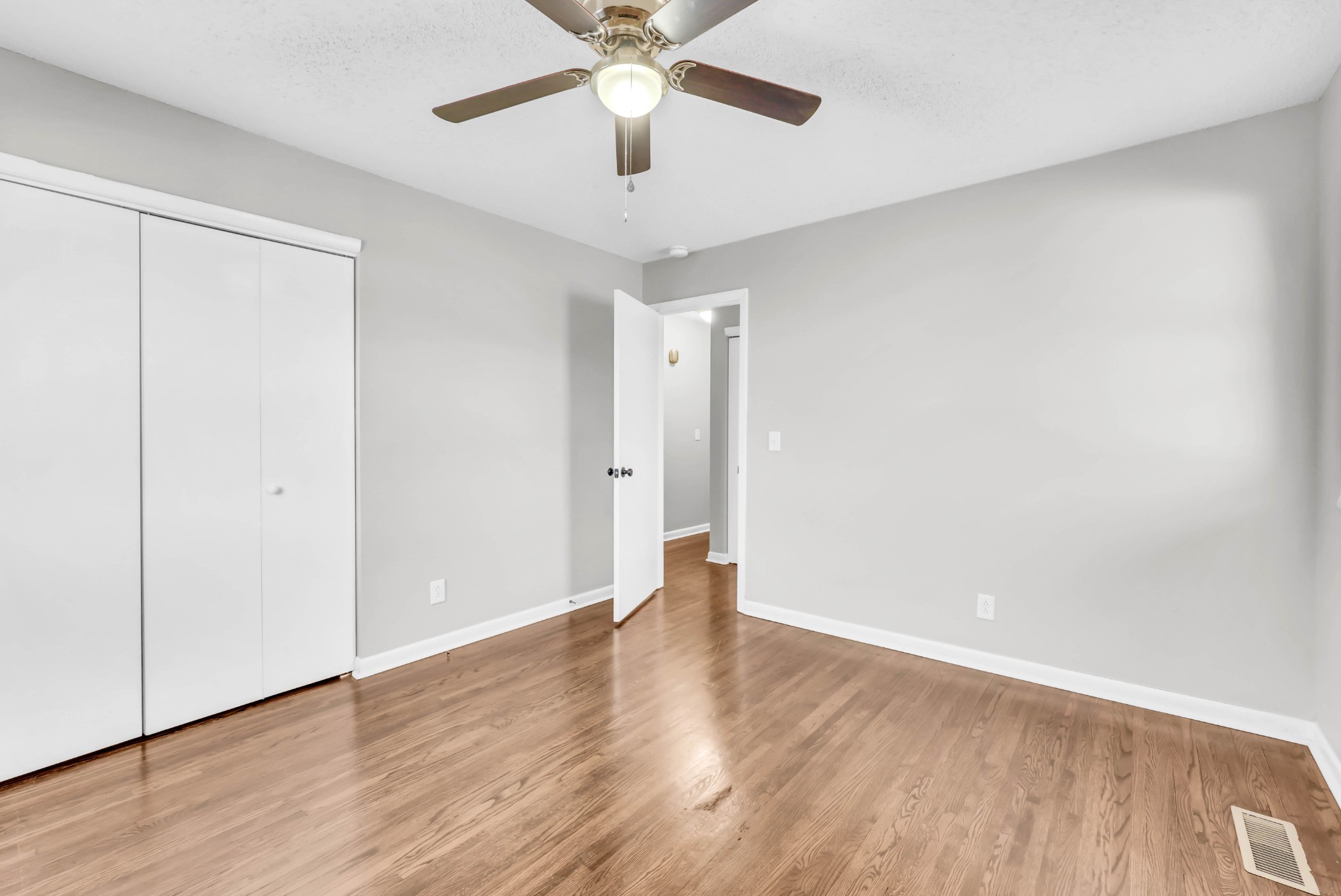 805 East 8th Avenue Springfield, TN 37172 - Photo 14 of 16 an empty room with wooden floor chandelier fan and closet area
