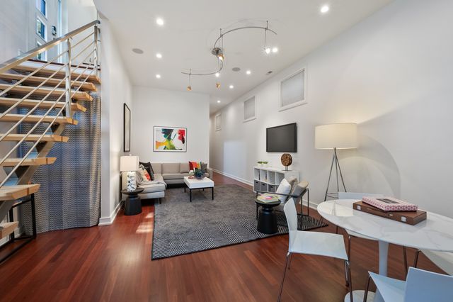 a living room with furniture and flat screen tv