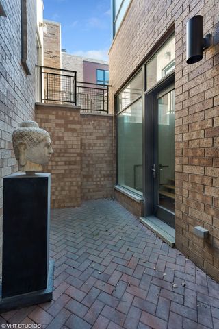 a view of front door of house and car parked on street