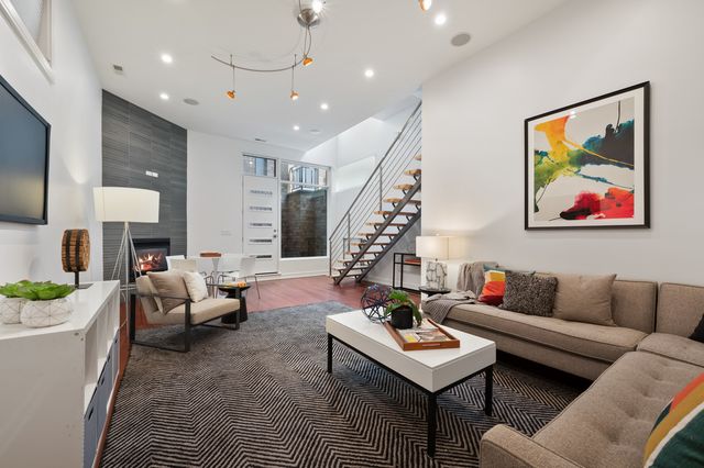 a living room with furniture and a painting