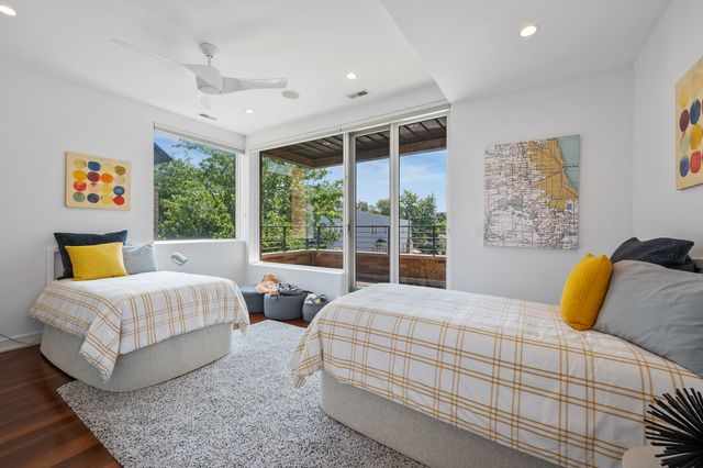 a bedroom with two beds and a large window