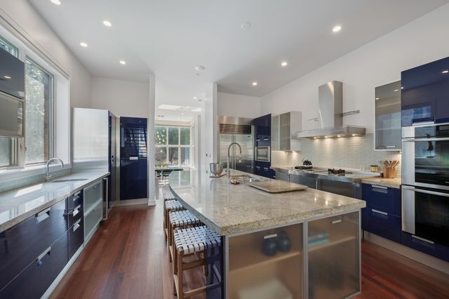 a kitchen with stainless steel appliances granite countertop a stove and a refrigerator