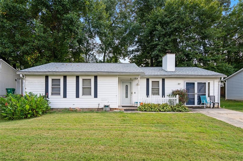 a front view of house with yard and green space