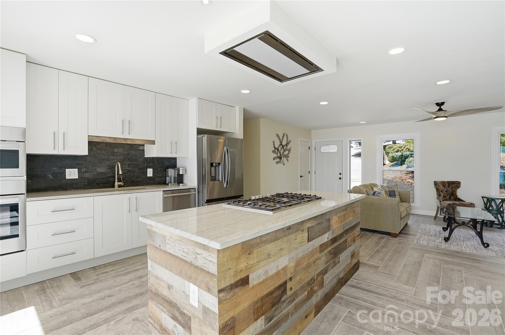 19011 Kailua Circle Tega Cay, SC 29708 - Photo 11 of 48 a kitchen with a stove a refrigerator and white cabinets