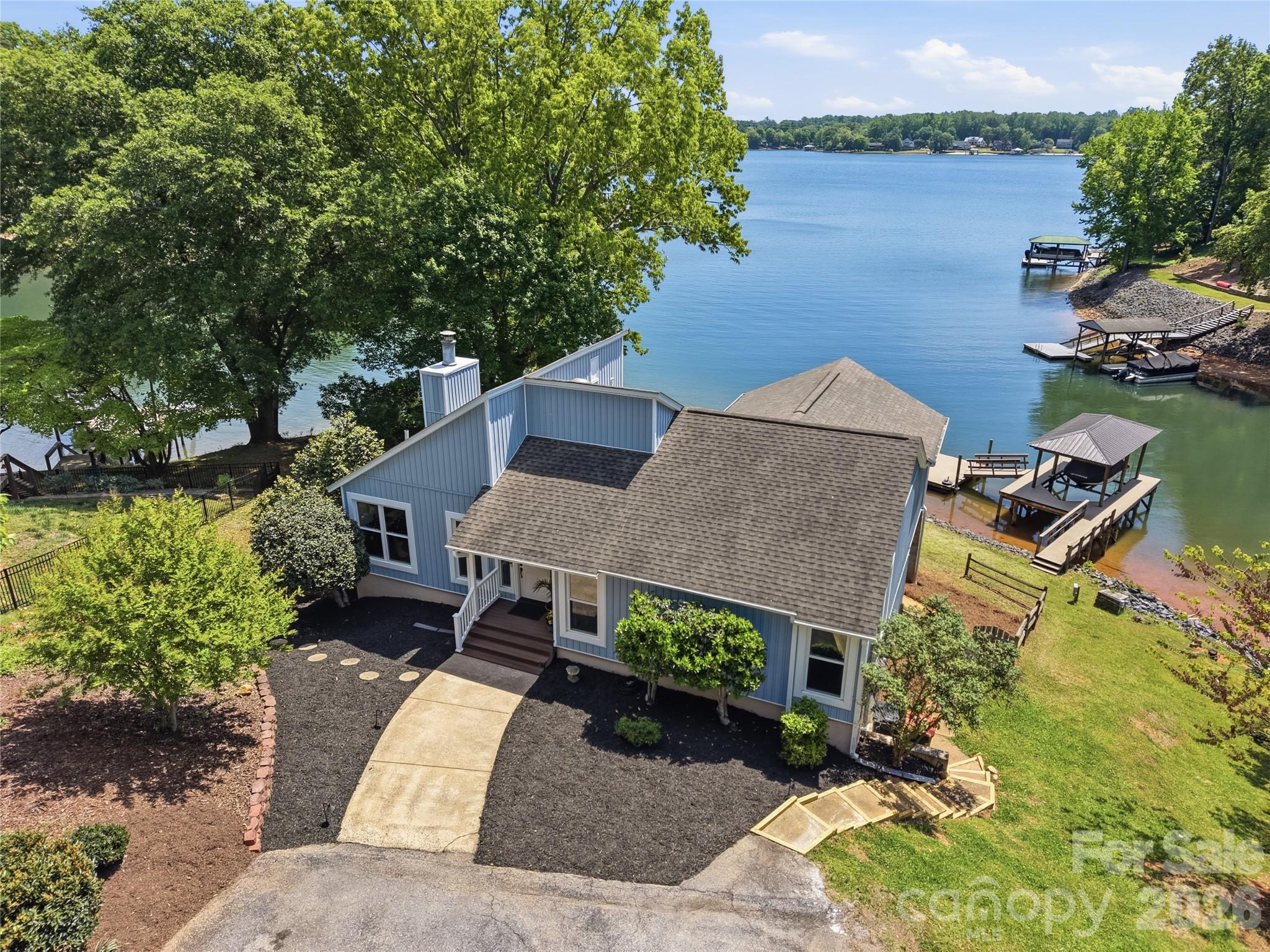 19011 Kailua Circle Tega Cay, SC 29708 - Photo 3 of 48 an aerial view of a house with a garden and lake view