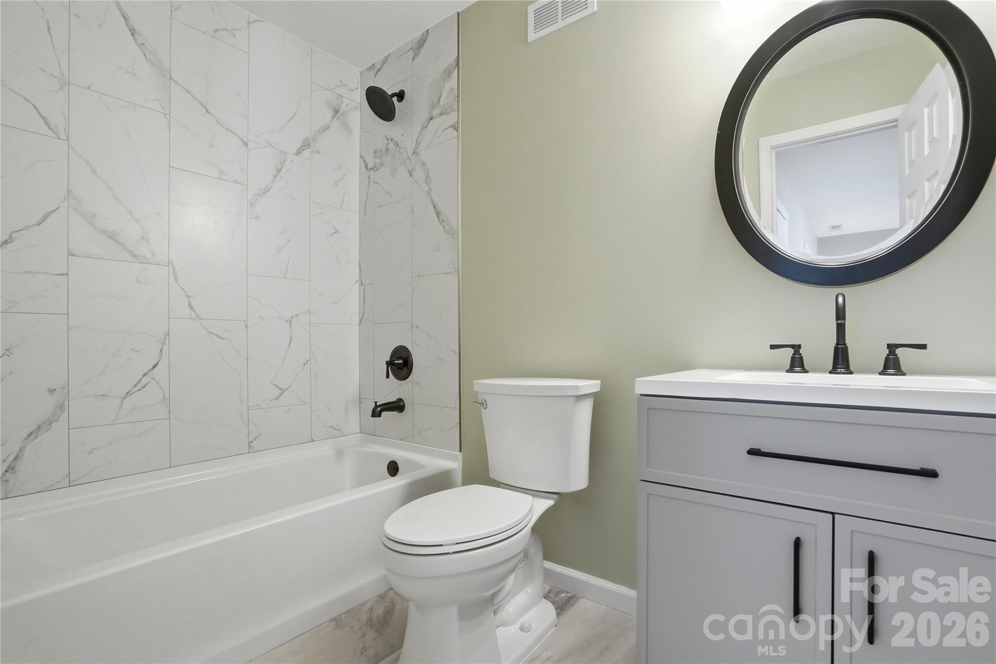 19011 Kailua Circle Tega Cay, SC 29708 - Photo 33 of 48 a bathroom with a sink a toilet and a mirror