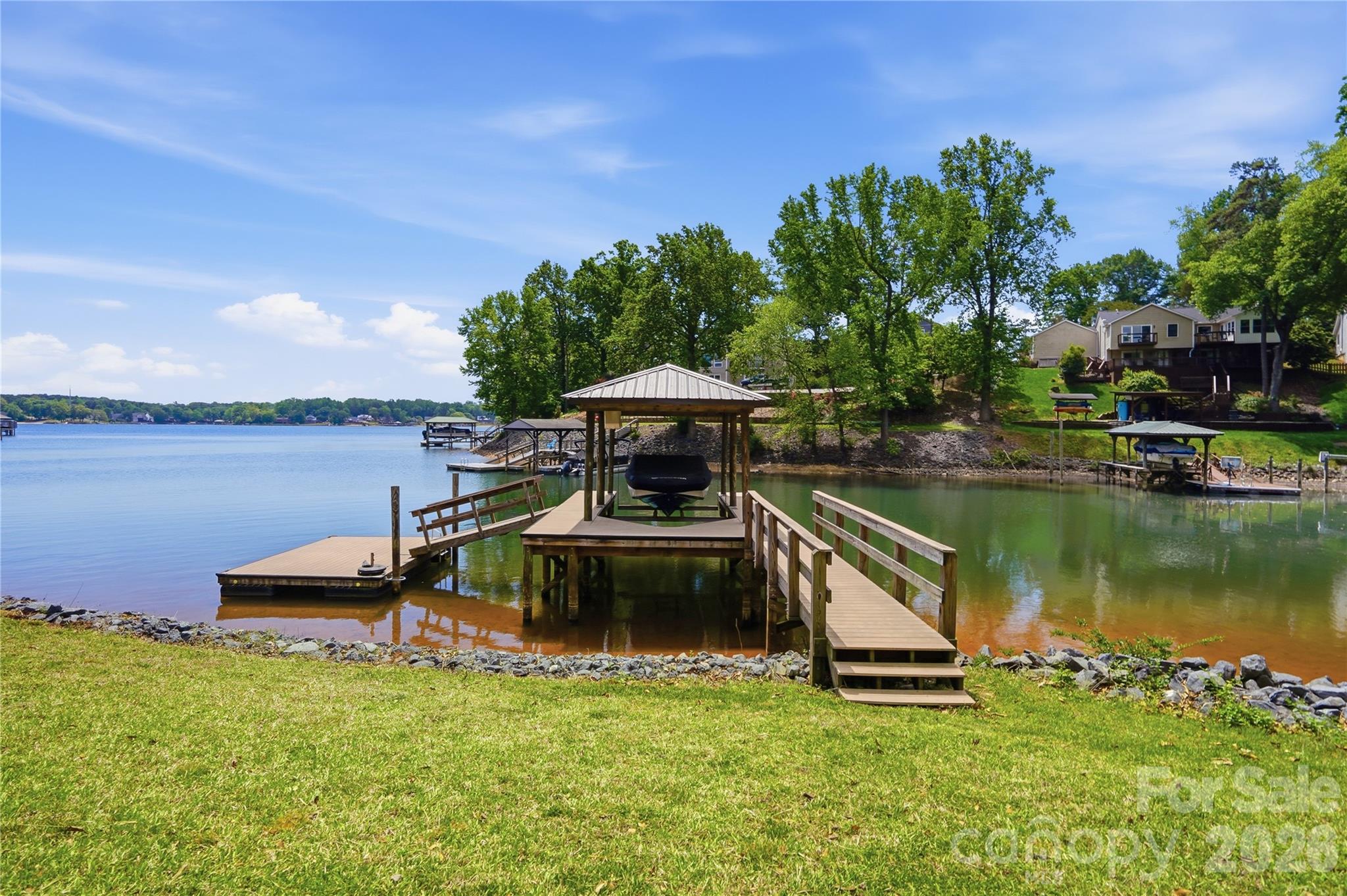 19011 Kailua Circle Tega Cay, SC 29708 - Photo 38 of 48 a view of a lake with a house in the background