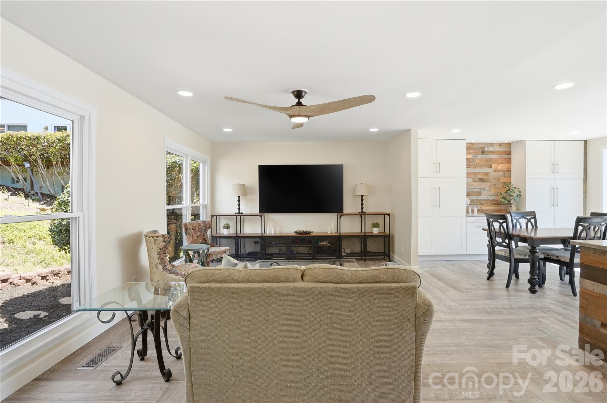 19011 Kailua Circle Tega Cay, SC 29708 - Photo 8 of 48 a living room with furniture a flat screen tv and a large window