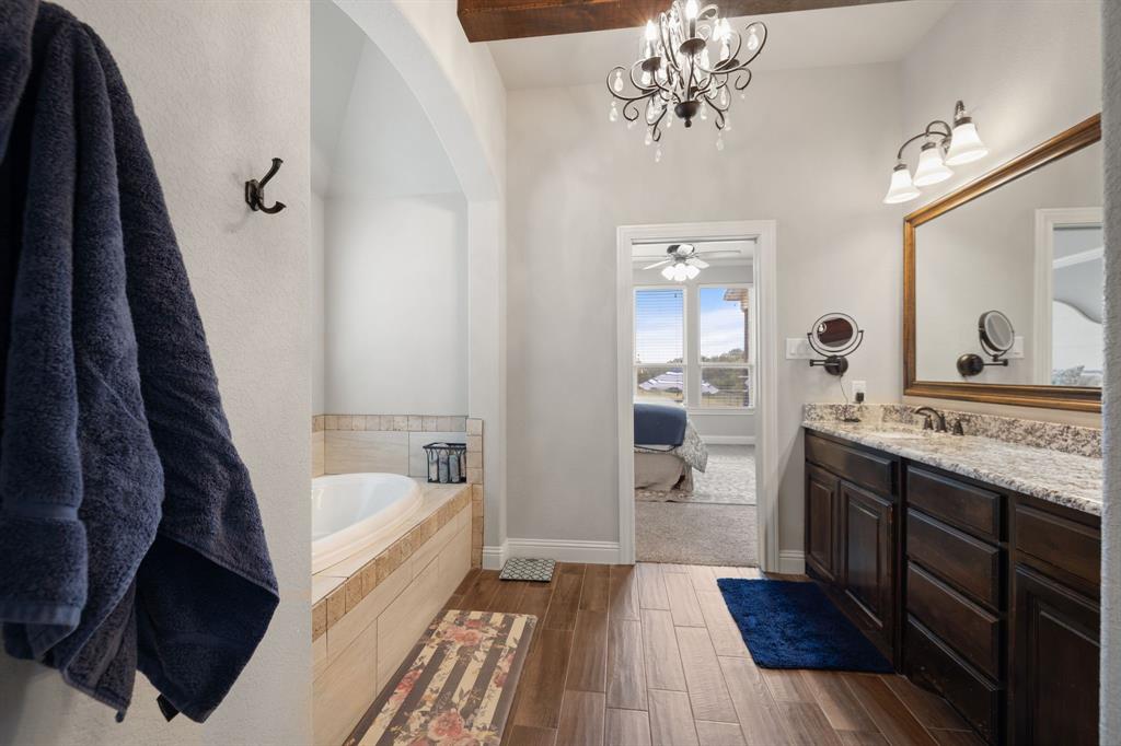 2103 Cash Point Court Granbury, TX 76049 - Photo 17 of 38 a bathroom with a tub sink and view