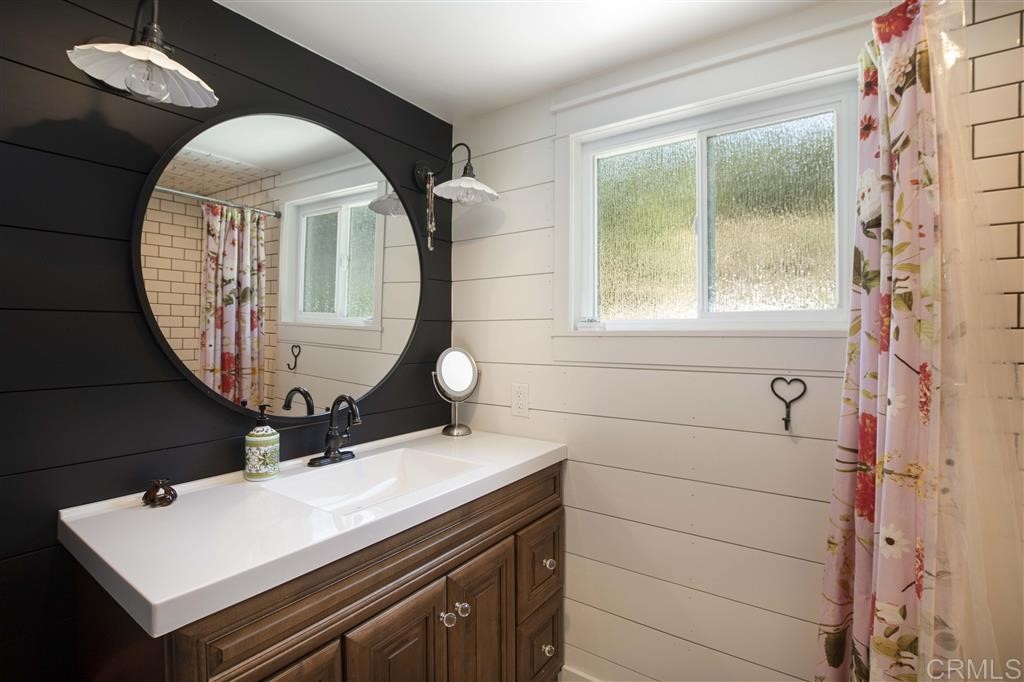 3945 Pala Mesa Drive Fallbrook, CA 92028 - Photo 11 of 23 a bathroom with a sink a vanity and a mirror