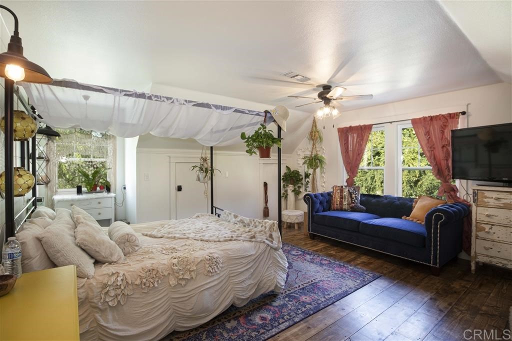 3945 Pala Mesa Drive Fallbrook, CA 92028 - Photo 12 of 23 a bedroom with a bed a couch and a flat tv screen on dresser