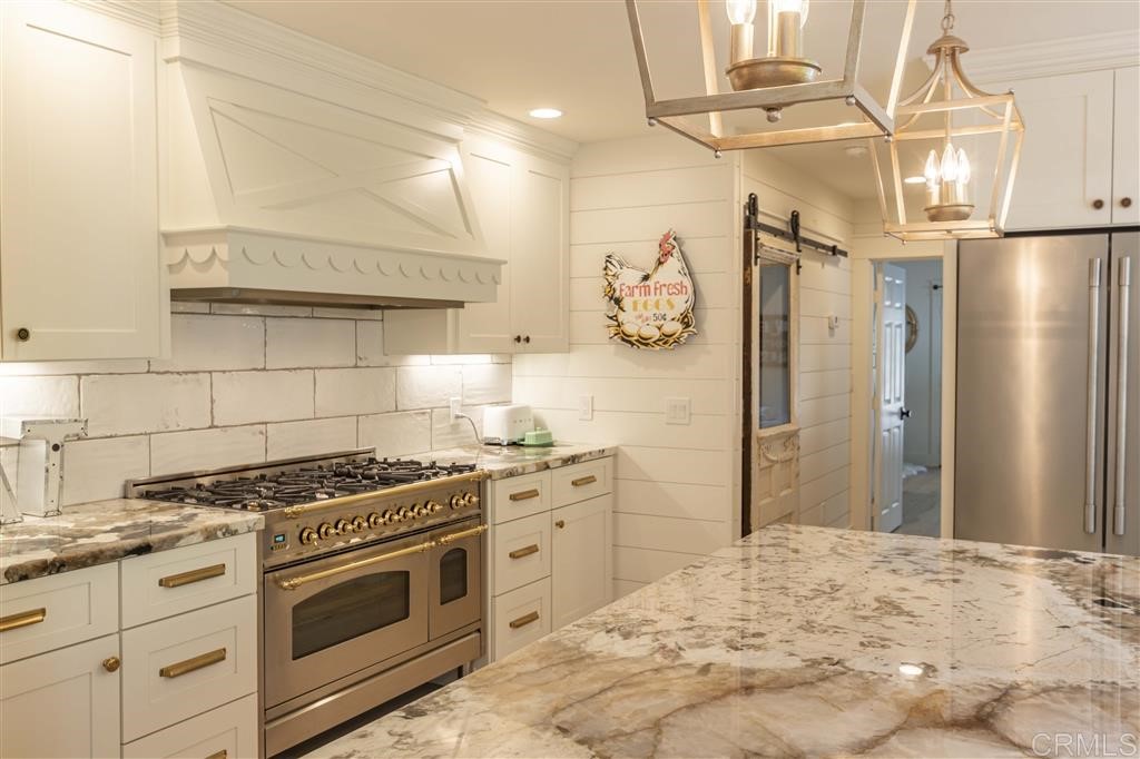 3945 Pala Mesa Drive Fallbrook, CA 92028 - Photo 6 of 23 a kitchen with stainless steel appliances a stove a refrigerator and cabinets