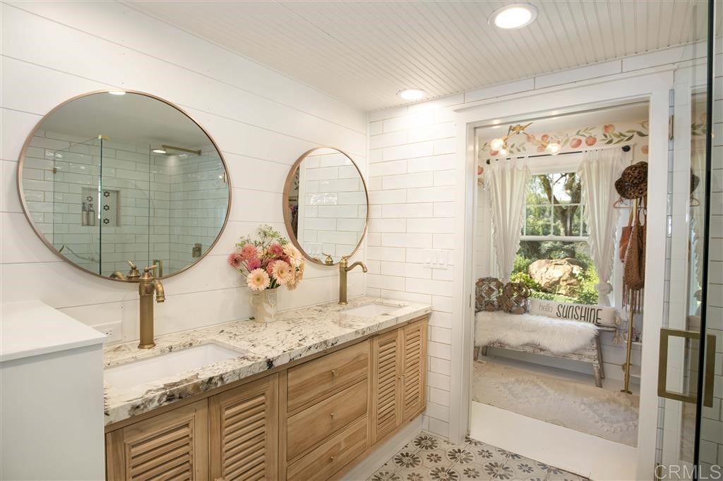 3945 Pala Mesa Drive Fallbrook, CA 92028 - Photo 8 of 23 a bathroom with a granite countertop sink and a mirror