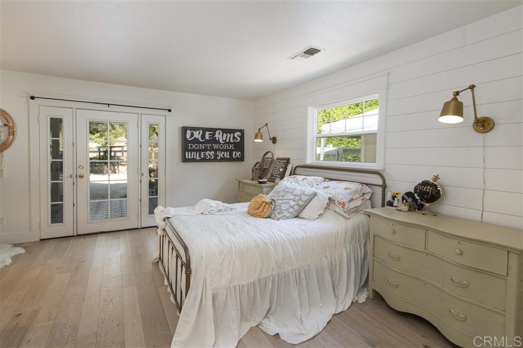 3945 Pala Mesa Drive Fallbrook, CA 92028 - Photo 10 of 23 a bedroom with a bed and wooden floor