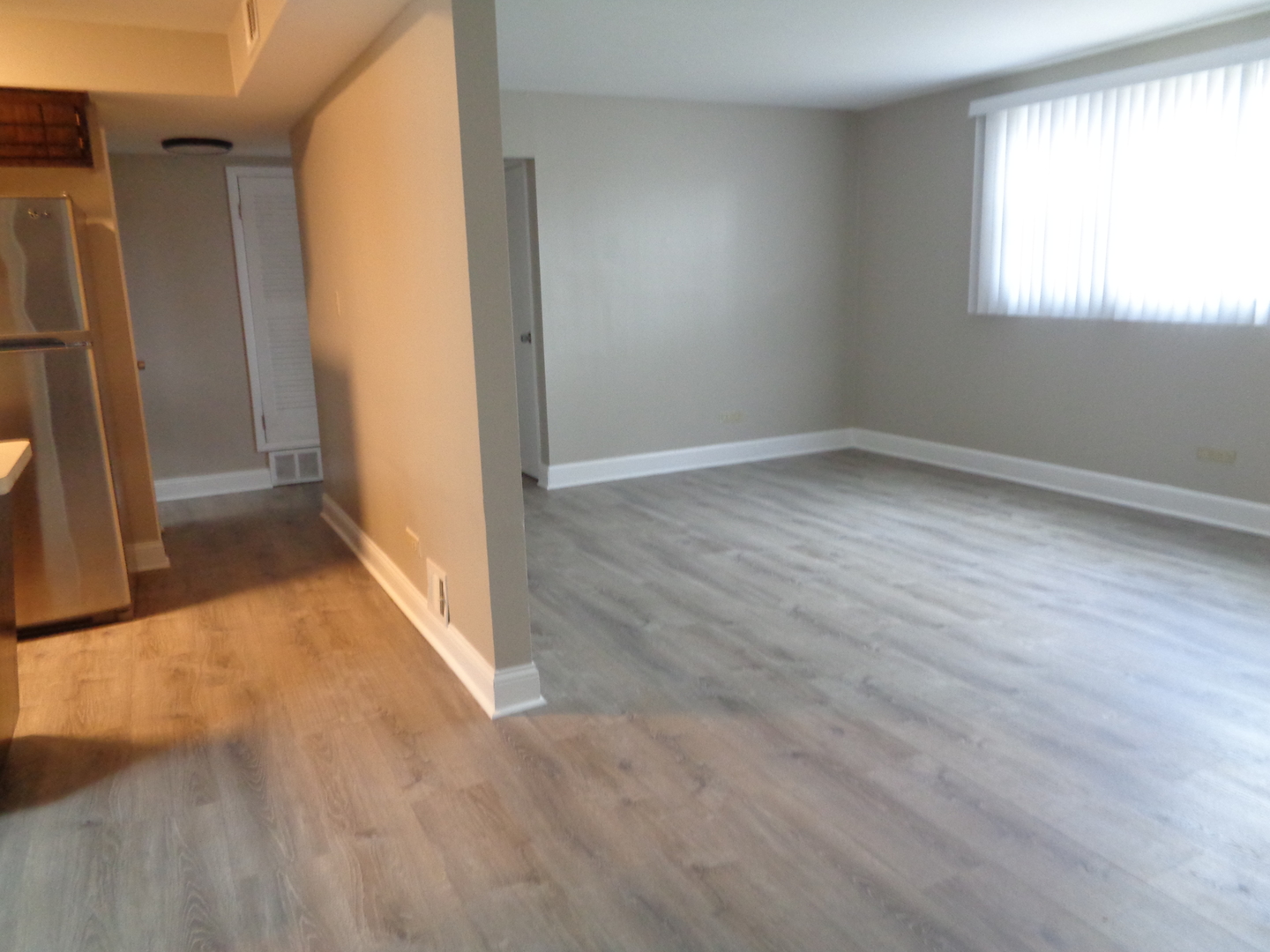 6834 West Lode Drive, Unit 1B Worth, IL 60482 - Photo 3 of 9 an empty room with windows