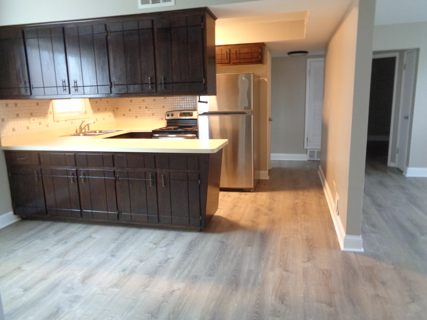 6834 West Lode Drive, Unit 1B Worth, IL 60482 - Photo 4 of 9 a kitchen with a sink and a refrigerator