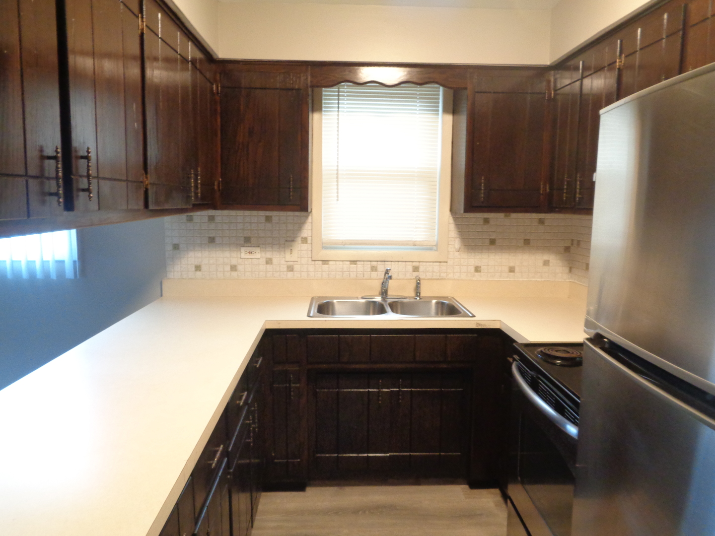 6834 West Lode Drive, Unit 1B Worth, IL 60482 - Photo 6 of 9 a kitchen with a sink and a refrigerator