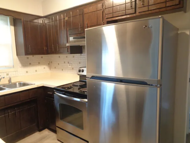 a kitchen with a sink and a refrigerator