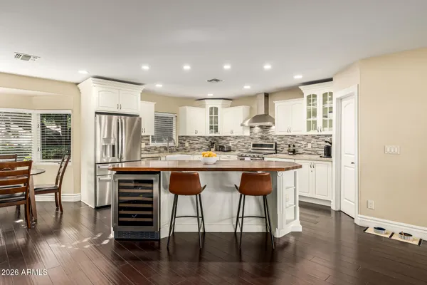 a kitchen with granite countertop white cabinets and appliances