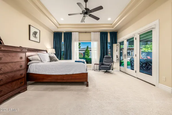 a bed sitting in a spacious bedroom next to a window