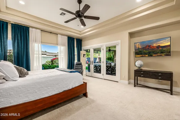 a bedroom with a bed and a flat screen tv