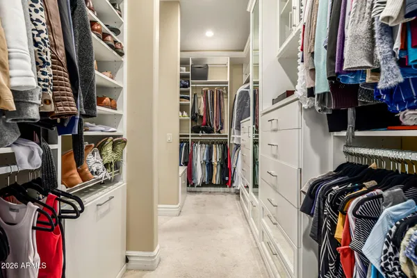 a bathroom with a granite countertop sink a mirror and a bathtub