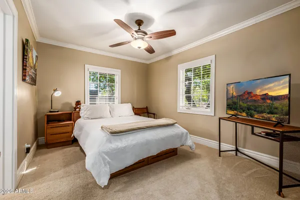 a bathroom with a granite countertop sink a mirror and shower