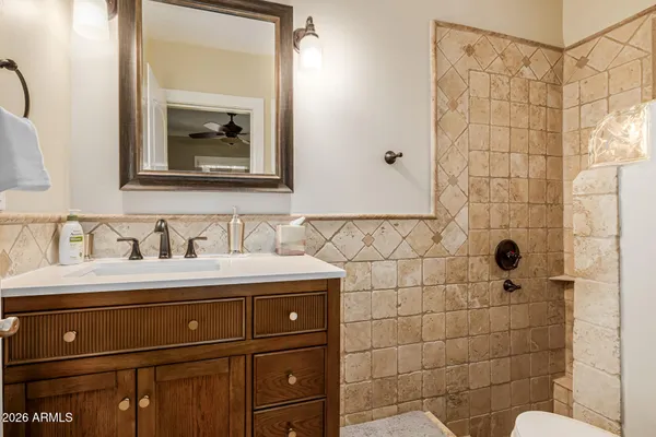 a bathroom with a sink toilet and mirror