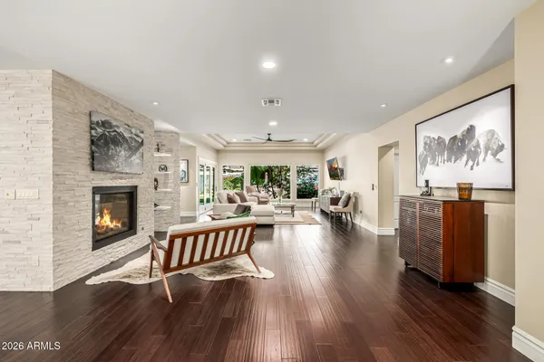 a dining room with furniture a fireplace and wooden floor