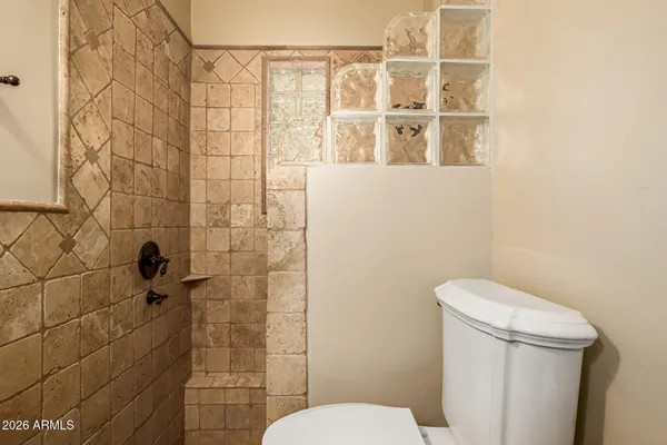 a bathroom with a shower a toilet and a sink